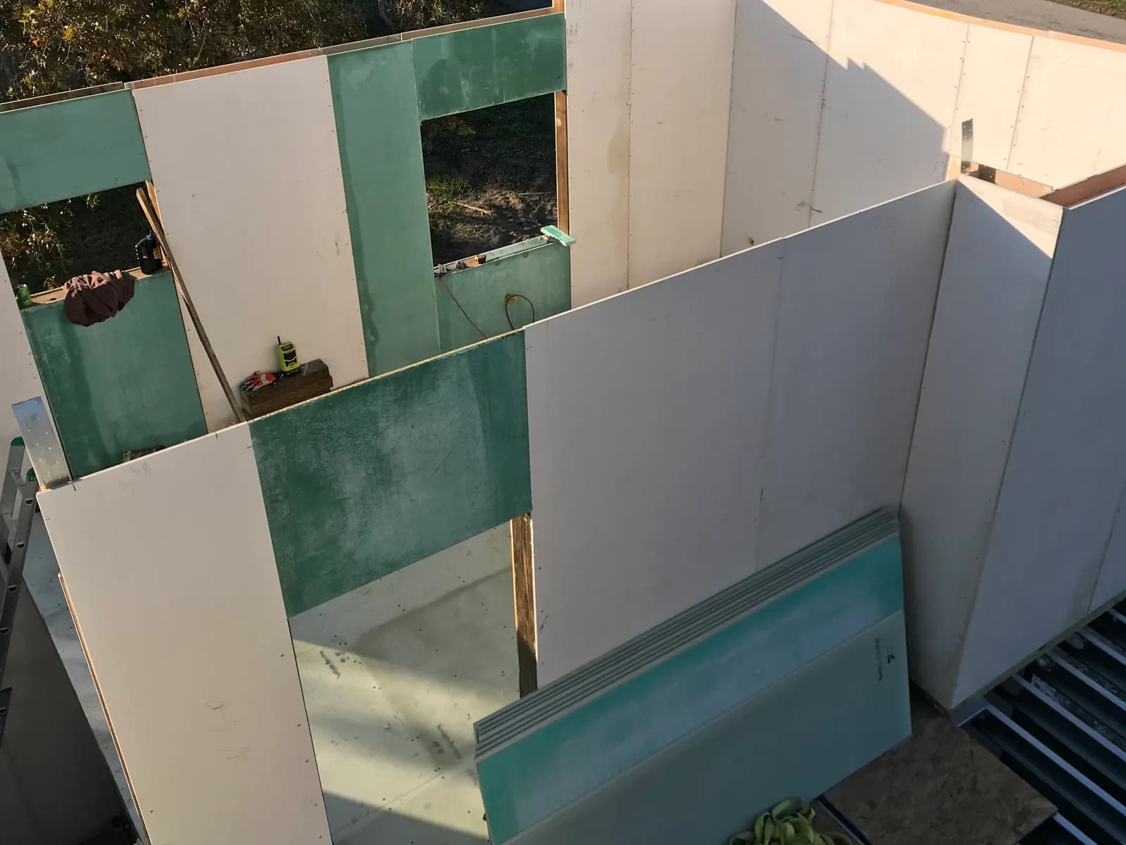 Structural insulated wall panels arranged around door and window openings during construction